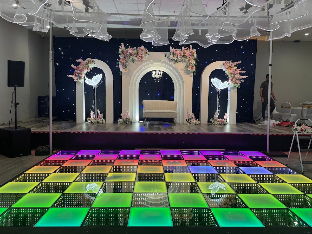 Colorful LED dance floor with floral stage backdrop