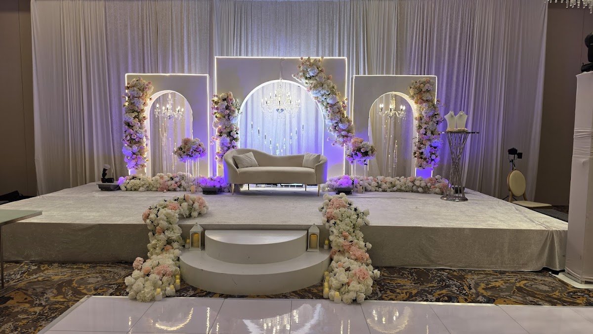 Wedding stage backdrop with drapes and flowers